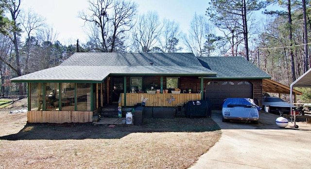 view of front of property featuring a garage and a sunroom