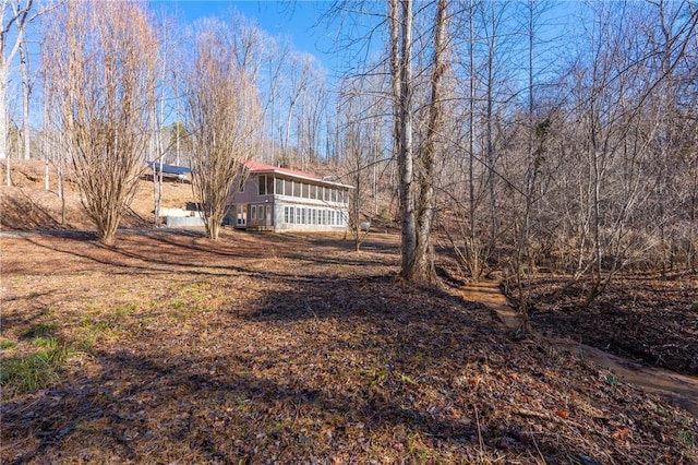 view of yard featuring a sunroom