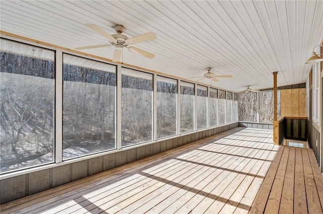 unfurnished sunroom with ceiling fan