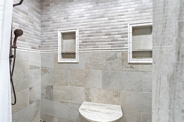 bathroom with a tile shower