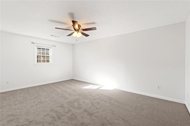 unfurnished room featuring carpet floors, a textured ceiling, and ceiling fan