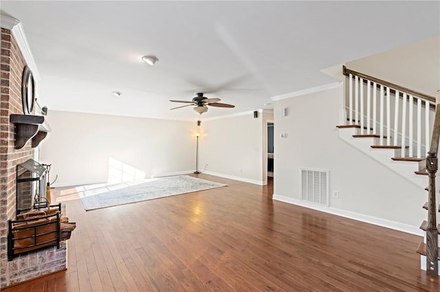 unfurnished living room with dark hardwood / wood-style flooring, crown molding, a fireplace, and ceiling fan