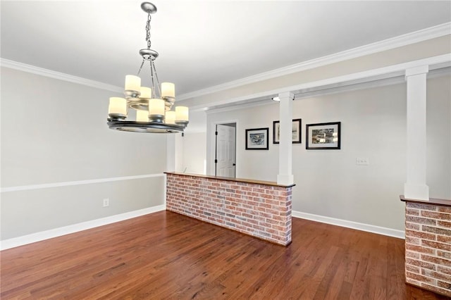 interior space featuring an inviting chandelier, ornamental molding, dark hardwood / wood-style floors, and decorative light fixtures