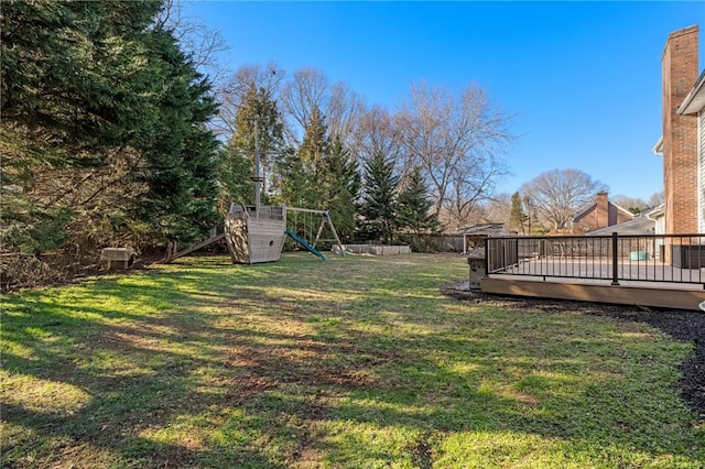 view of yard featuring a playground and a wooden deck