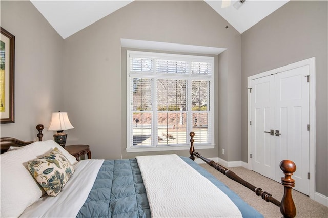 bedroom featuring multiple windows, lofted ceiling, and carpet