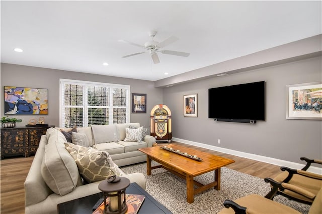 living room with hardwood / wood-style flooring and ceiling fan