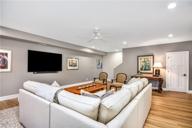 living room with light hardwood / wood-style floors and ceiling fan