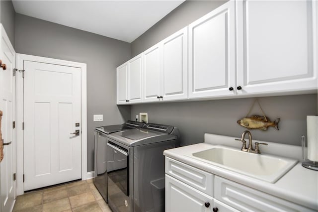 laundry area featuring cabinets, independent washer and dryer, and sink