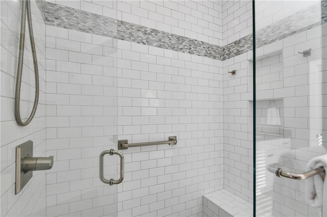 bathroom featuring a shower with shower door