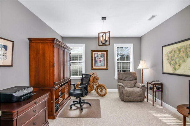 office area with light carpet and an inviting chandelier