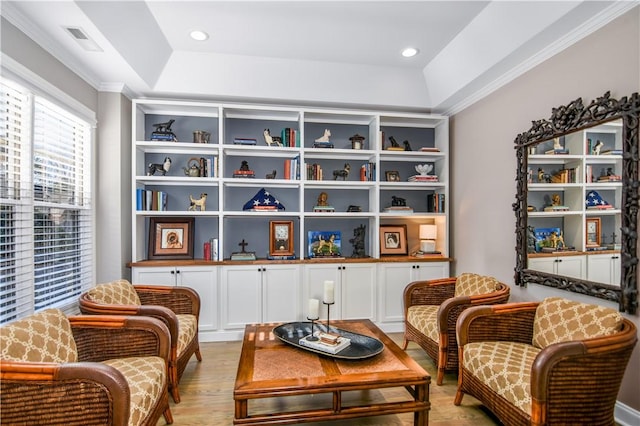 sitting room featuring ornamental molding and light wood-type flooring