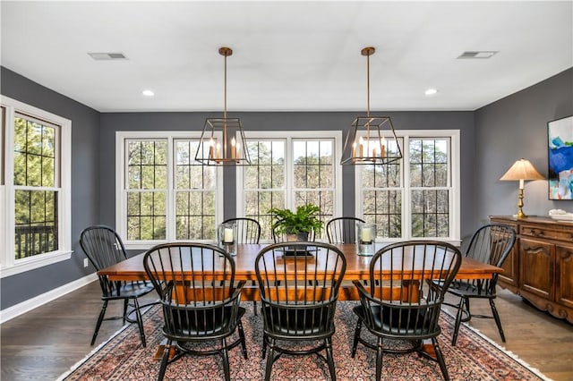 dining space with wood-type flooring and plenty of natural light