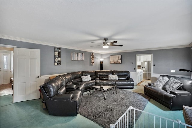 living room featuring ornamental molding, carpet, and ceiling fan