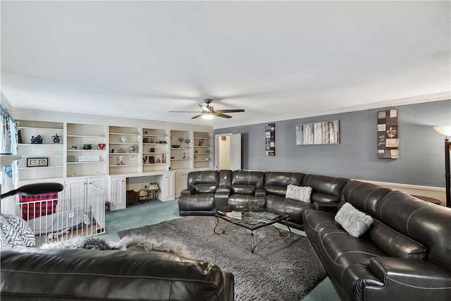 living room featuring ornamental molding, carpet floors, and ceiling fan