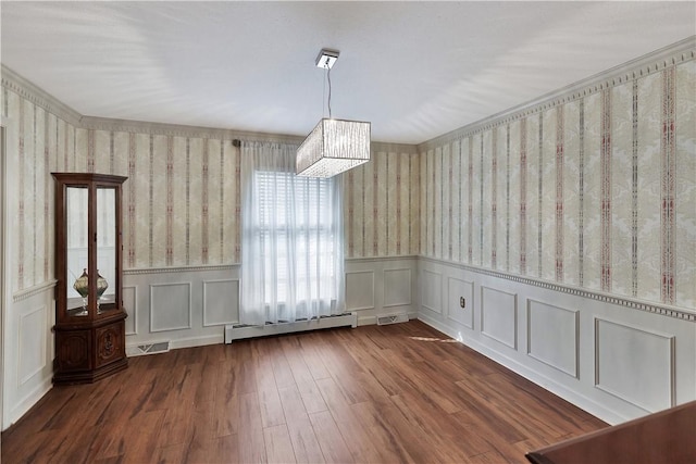 unfurnished dining area with dark hardwood / wood-style flooring and baseboard heating