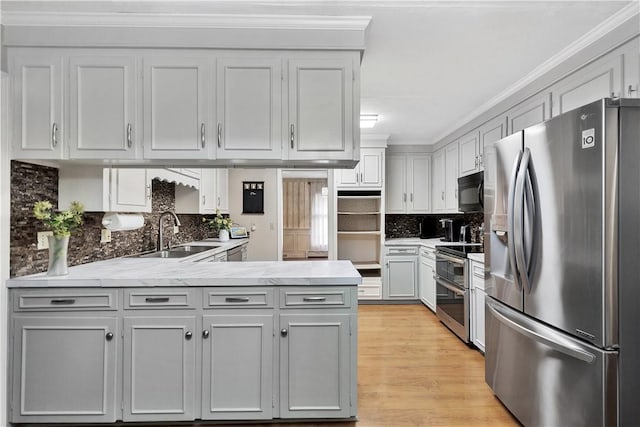 kitchen featuring gray cabinetry, sink, ornamental molding, and stainless steel appliances