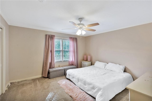 carpeted bedroom with crown molding and ceiling fan