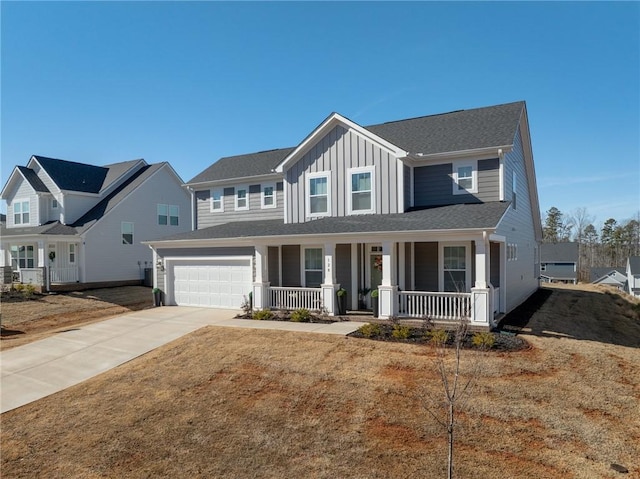 view of front of house featuring a garage, a front yard, and a porch