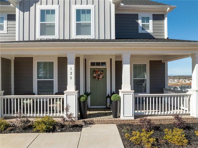 view of exterior entry featuring covered porch