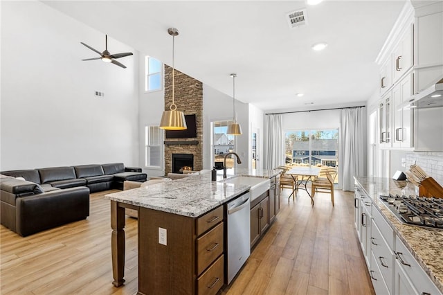 kitchen featuring stainless steel appliances, sink, and white cabinets