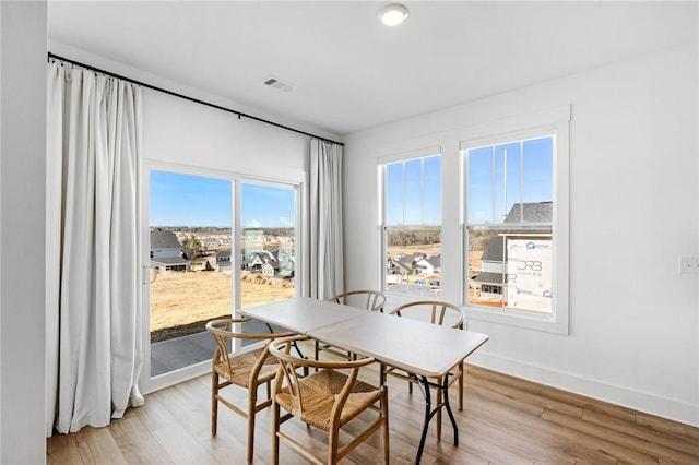 dining space featuring light hardwood / wood-style floors