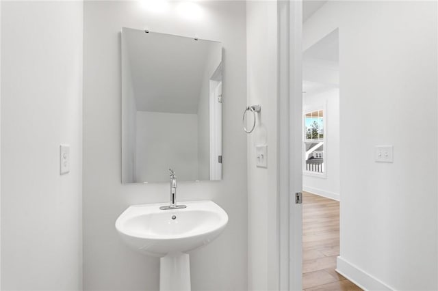 bathroom with hardwood / wood-style flooring and sink