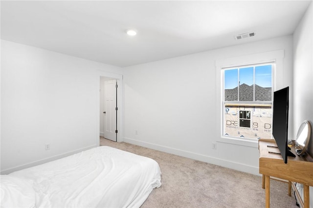 bedroom with light colored carpet and multiple windows