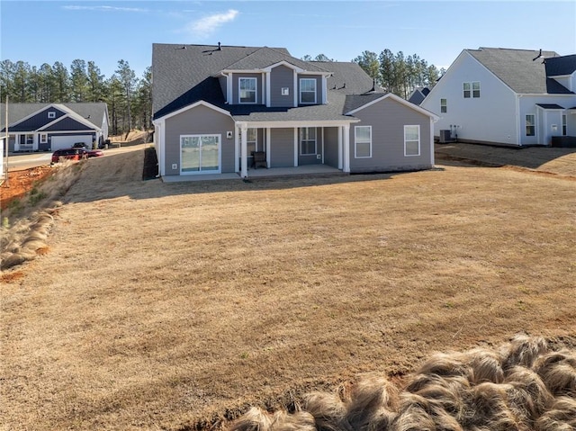 rear view of house with a yard, central AC, and a patio