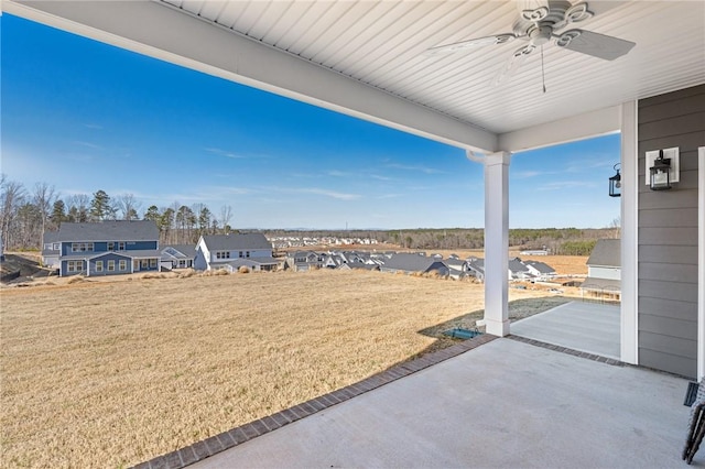 view of yard with a patio and ceiling fan