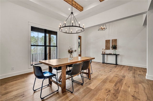 dining space featuring beam ceiling and light hardwood / wood-style floors