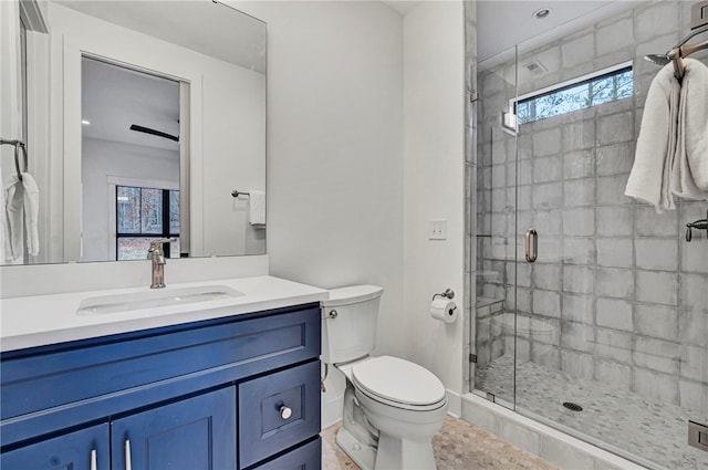 bathroom featuring vanity, a wealth of natural light, an enclosed shower, and toilet