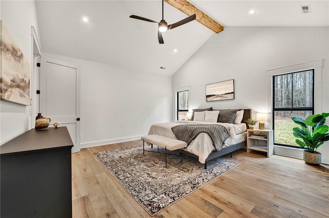 bedroom featuring ceiling fan, high vaulted ceiling, beam ceiling, and light hardwood / wood-style flooring