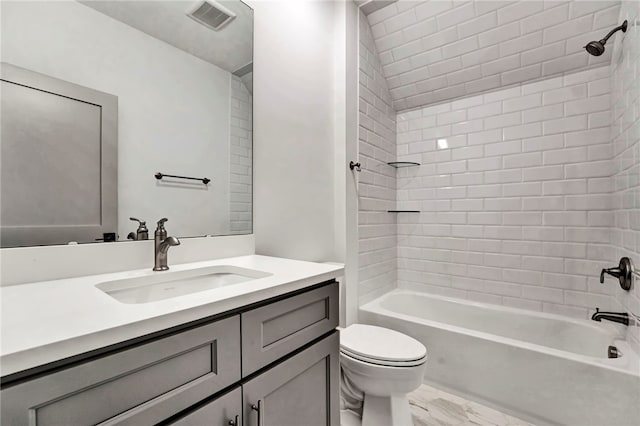 full bathroom with vanity, toilet, and tiled shower / bath