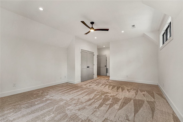 interior space featuring ceiling fan and light carpet