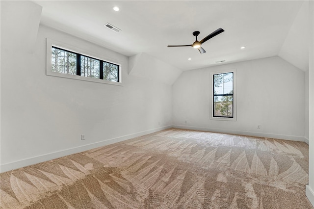 bonus room featuring lofted ceiling, light colored carpet, and ceiling fan