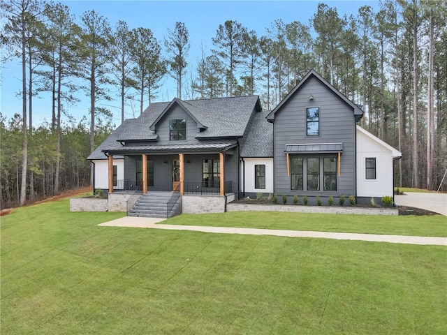 modern farmhouse style home with a porch and a front lawn