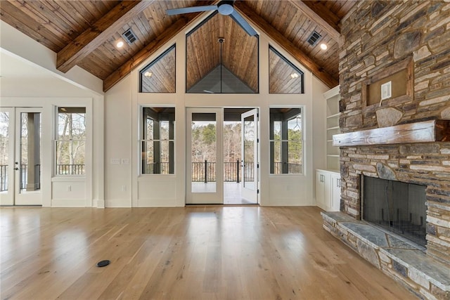 unfurnished living room with light hardwood / wood-style floors, plenty of natural light, wood ceiling, and french doors