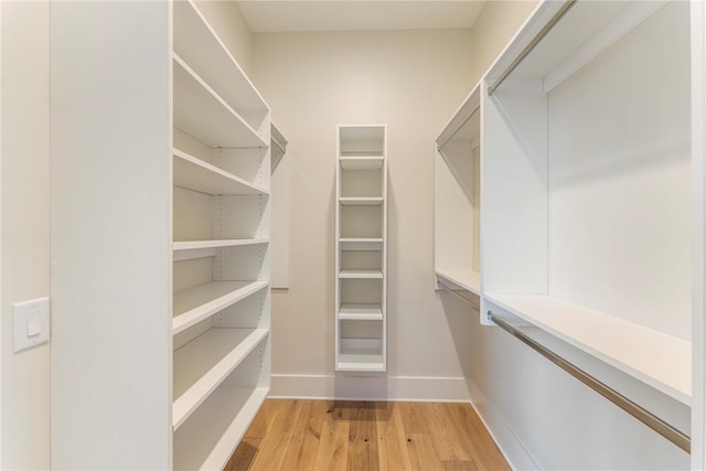 spacious closet featuring light hardwood / wood-style floors