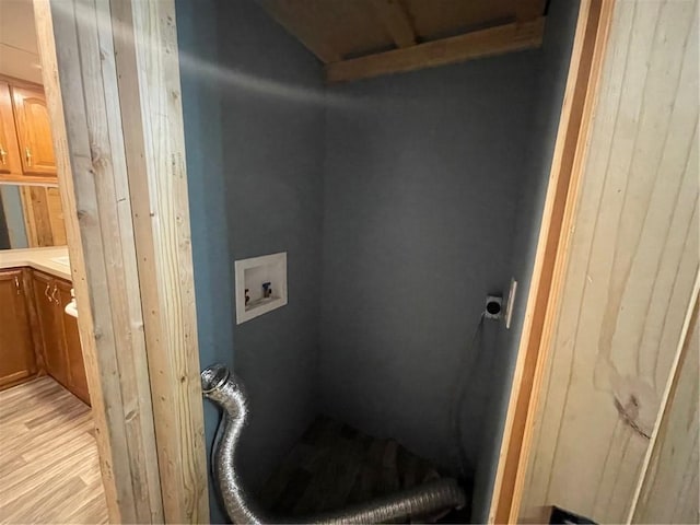 washroom featuring cabinets, washer hookup, light hardwood / wood-style floors, and electric dryer hookup