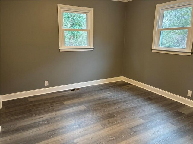 empty room with dark wood-type flooring