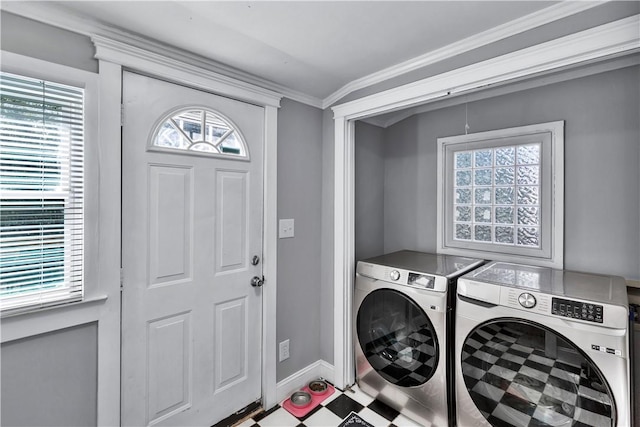 clothes washing area with separate washer and dryer, plenty of natural light, and ornamental molding