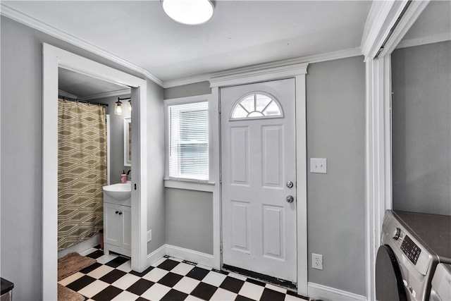 foyer entrance featuring crown molding and washing machine and dryer