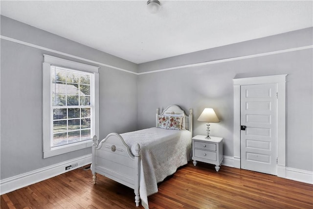 bedroom featuring dark hardwood / wood-style floors