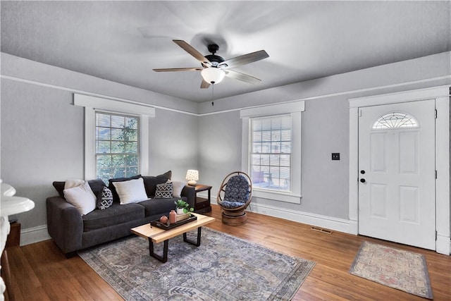 living room with hardwood / wood-style flooring and ceiling fan