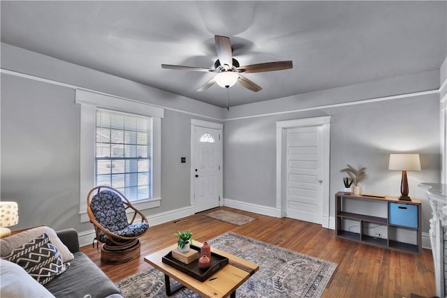 living room with dark hardwood / wood-style floors and ceiling fan