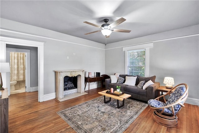 living room featuring ceiling fan and hardwood / wood-style floors