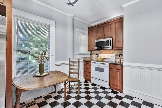 kitchen with crown molding, decorative backsplash, and white range with electric cooktop