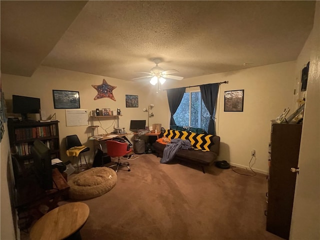 sitting room featuring a textured ceiling, carpet floors, a ceiling fan, and baseboards