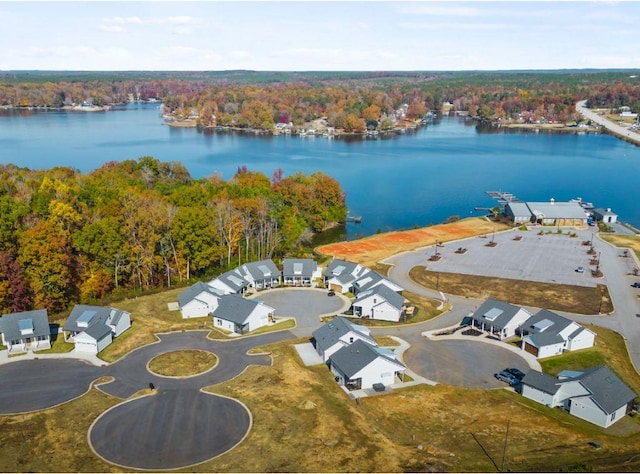 aerial view featuring a wooded view and a water view