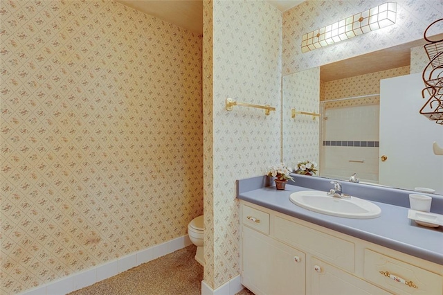 bathroom with vanity, a shower, and toilet